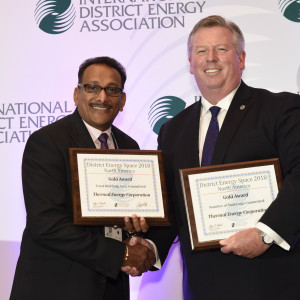 Ram Goonie, left, accepts TECO's District Energy Space Gold Awards from IDEA's Rob Thornton.