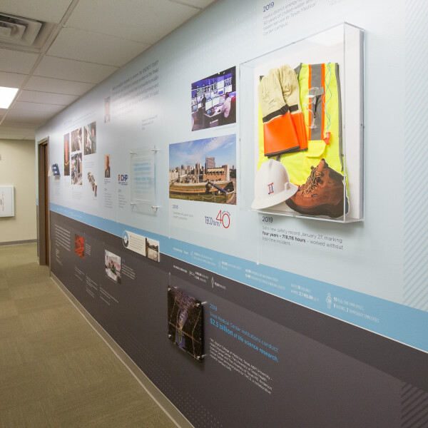 The second timeline wall includes a shadow box with safety gear.