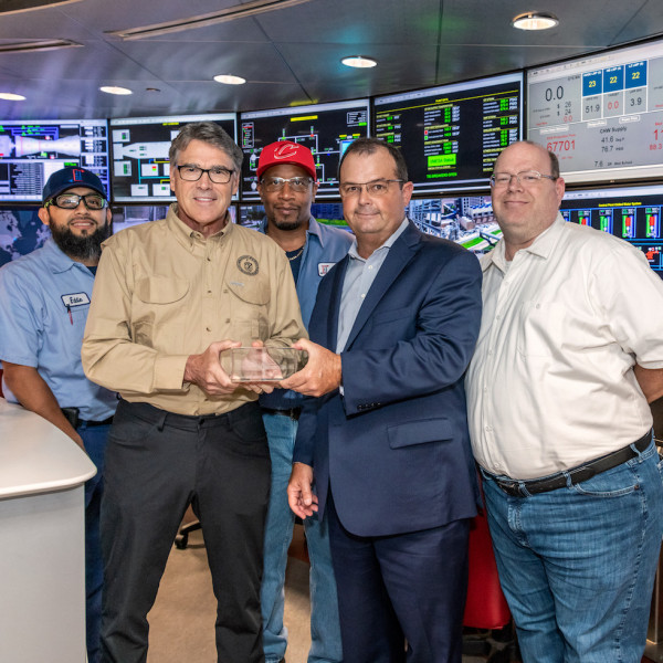 At center, TECO's Steve Swinson presents a tour memento to Energy Secretary Rick Perry, with TECO's Eddie Martinez at left and Stephen Nagy at right.